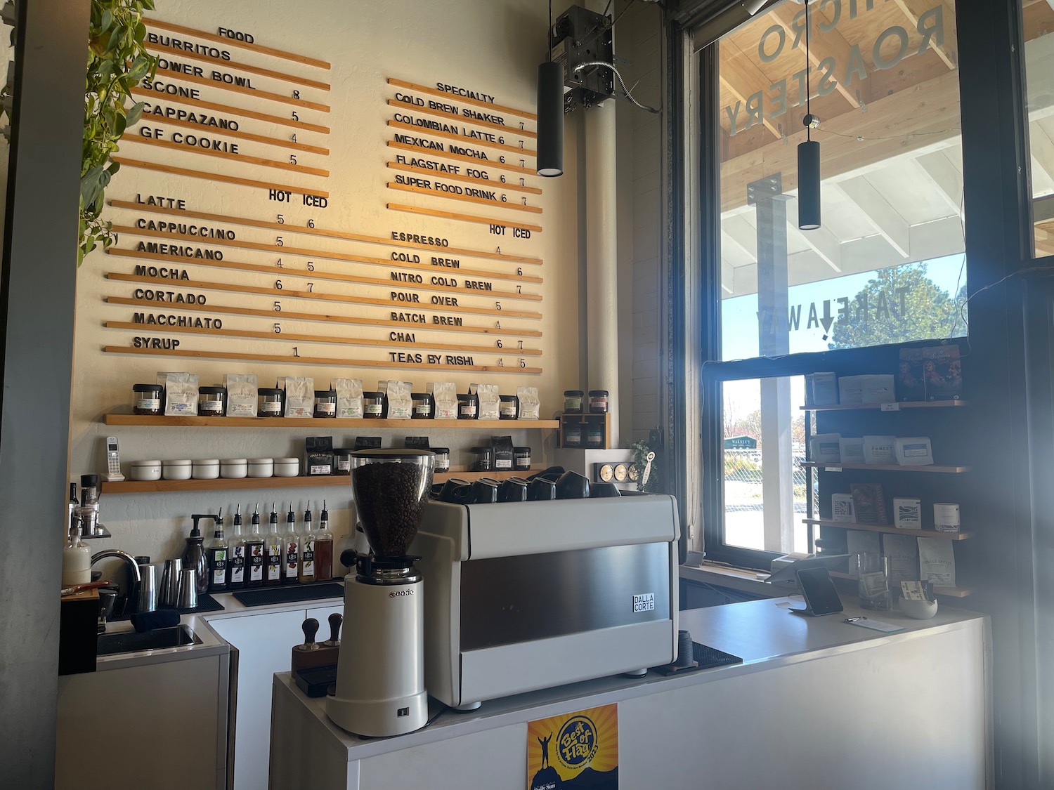 a coffee shop with a counter and a sign on the wall