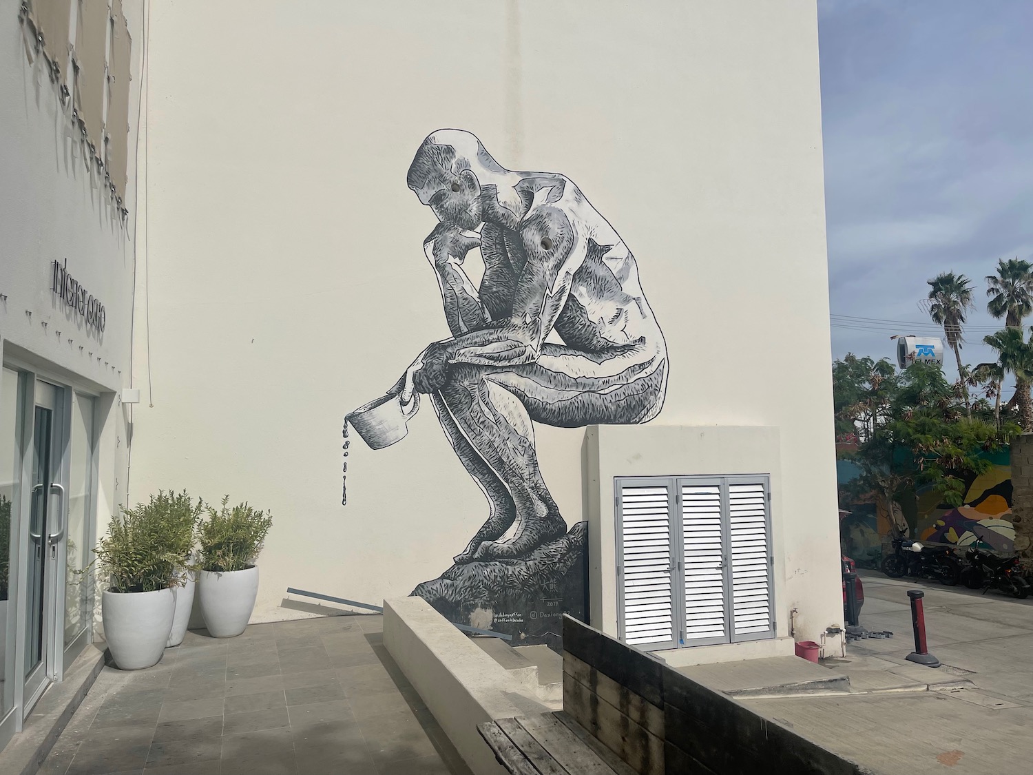 a mural of a man sitting on a wall