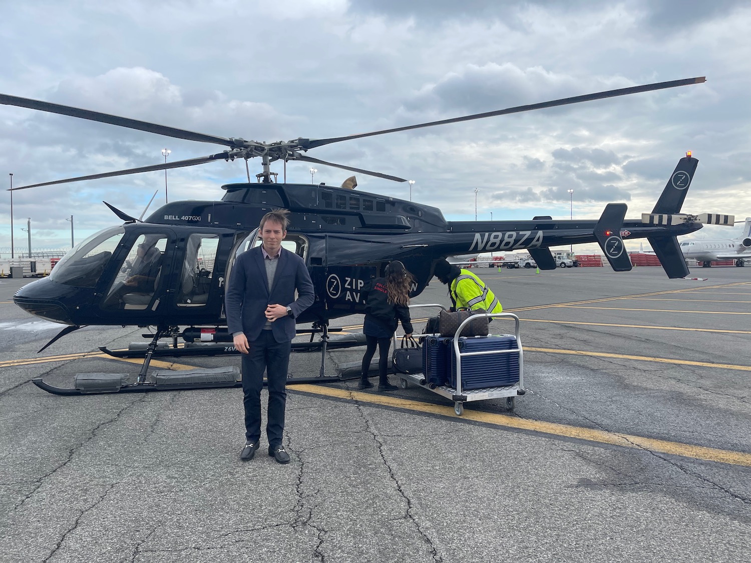 a man standing next to a helicopter