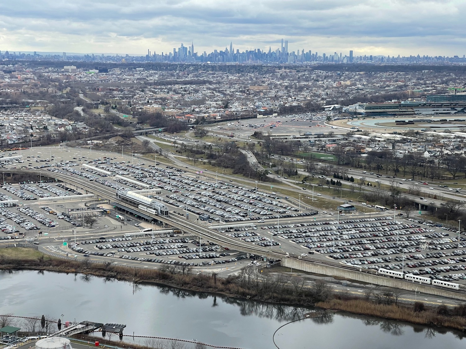 a parking lot with cars and a city in the background