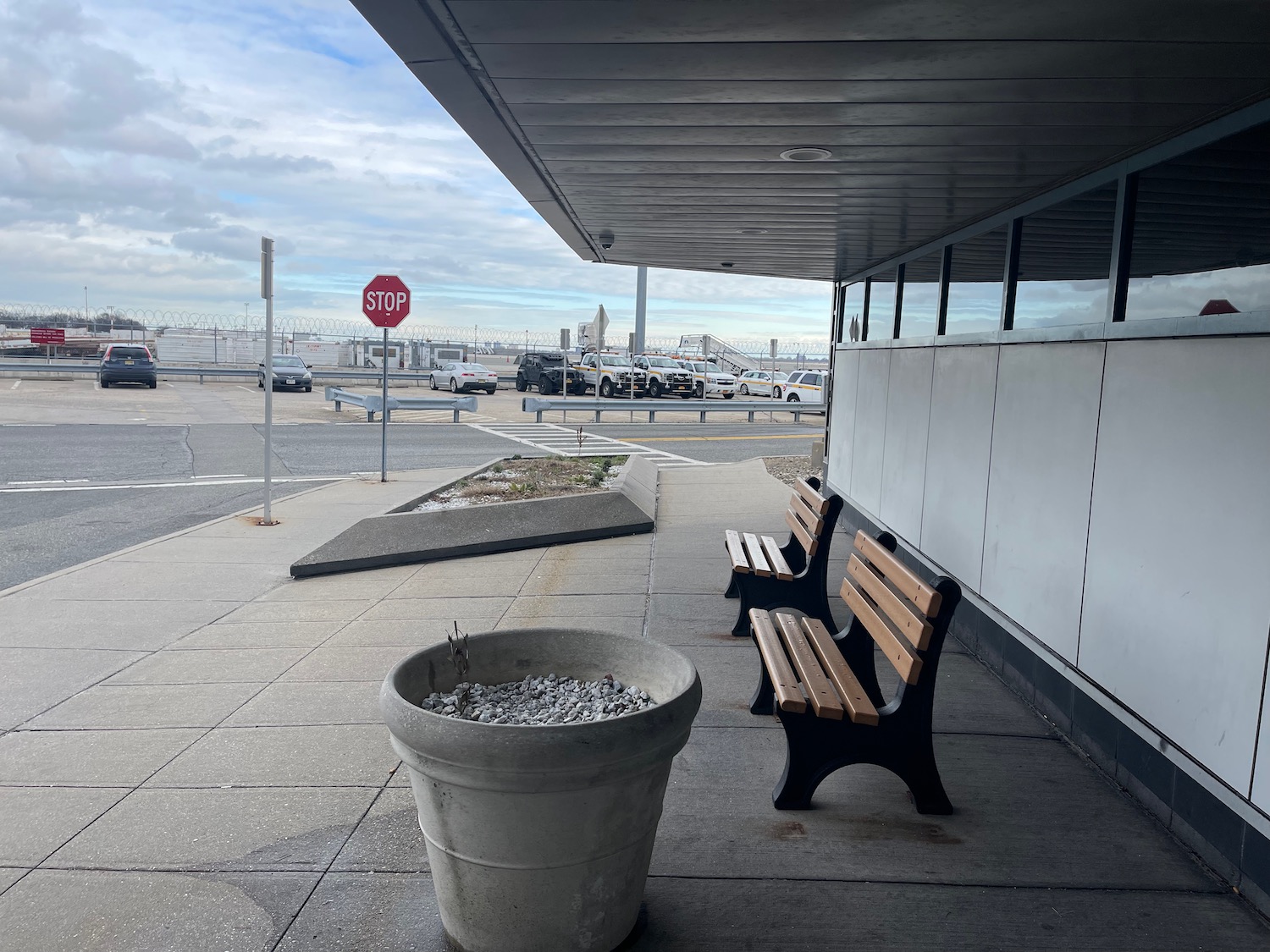 a bench and a planter on a sidewalk