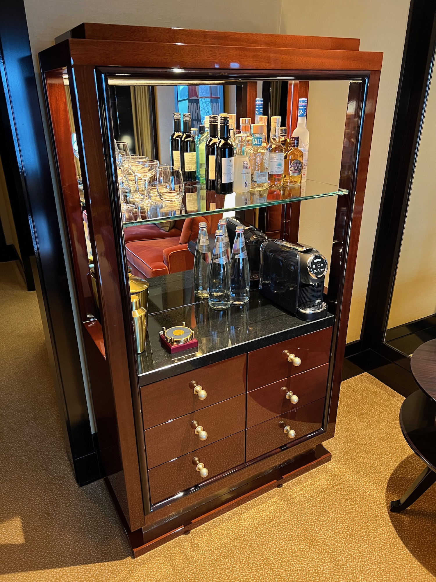 a liquor cabinet with bottles and glasses