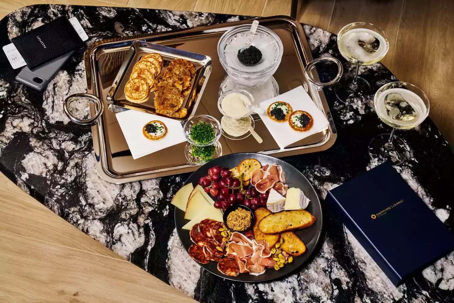 a tray of food and drinks on a marble table