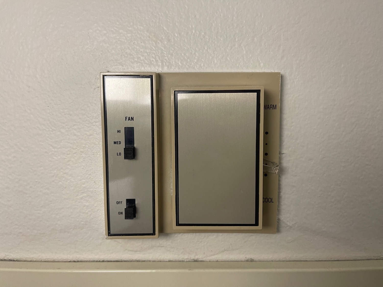 a switch and a fan on a wall