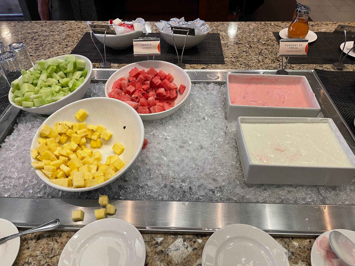 a buffet with different types of fruit on ice