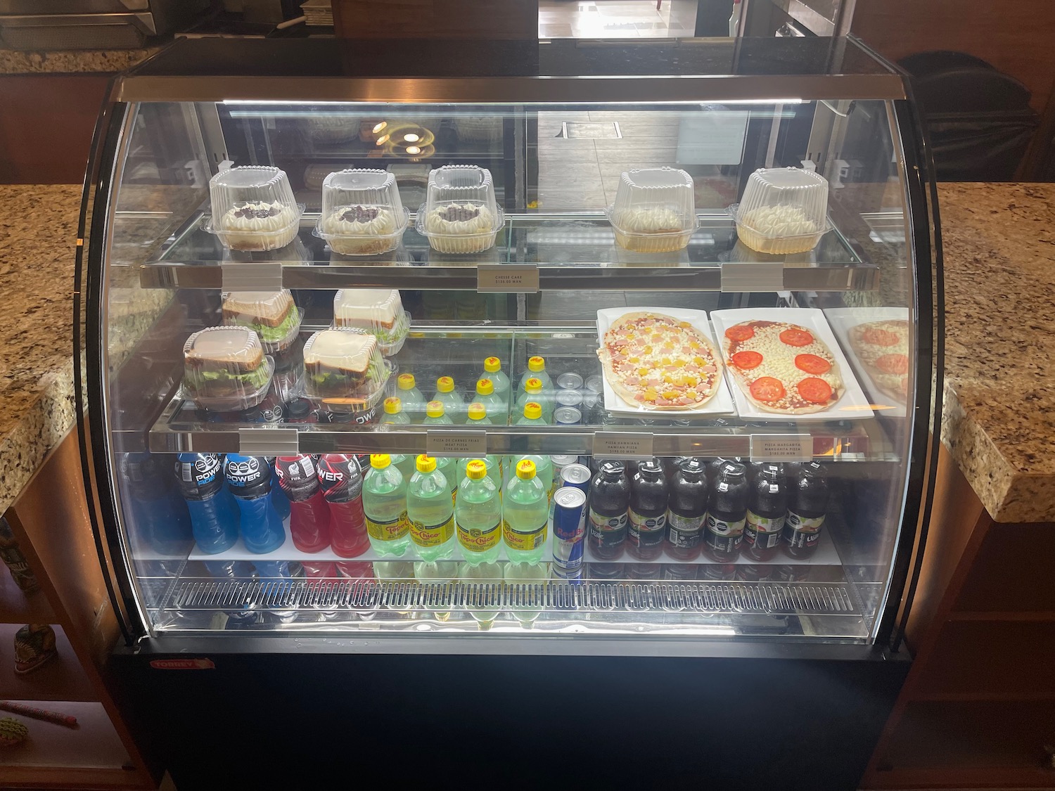 a display case with food and drinks