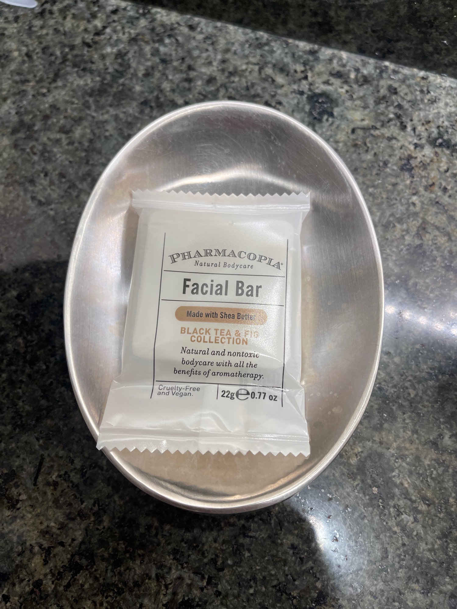 a small packet of facial bar in a silver bowl