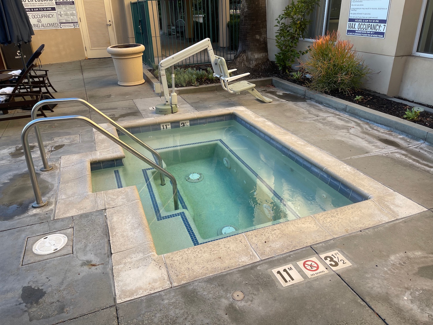 a pool with stairs and a chair in the back
