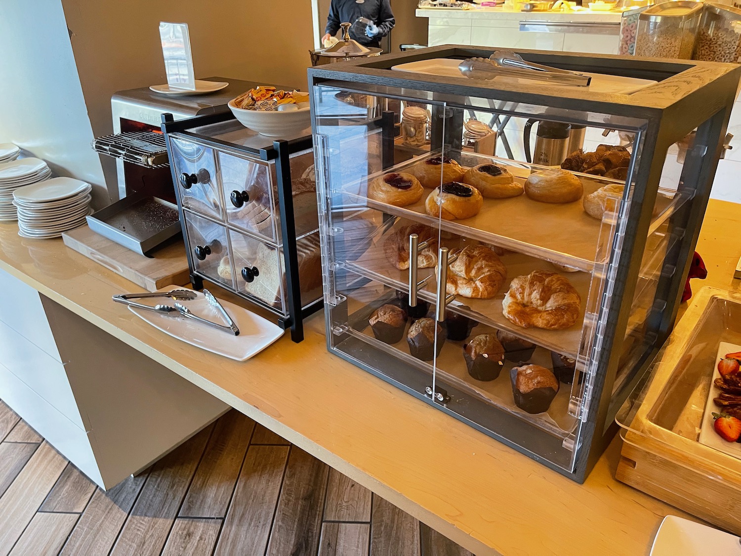 a bakery display case with pastries on a counter