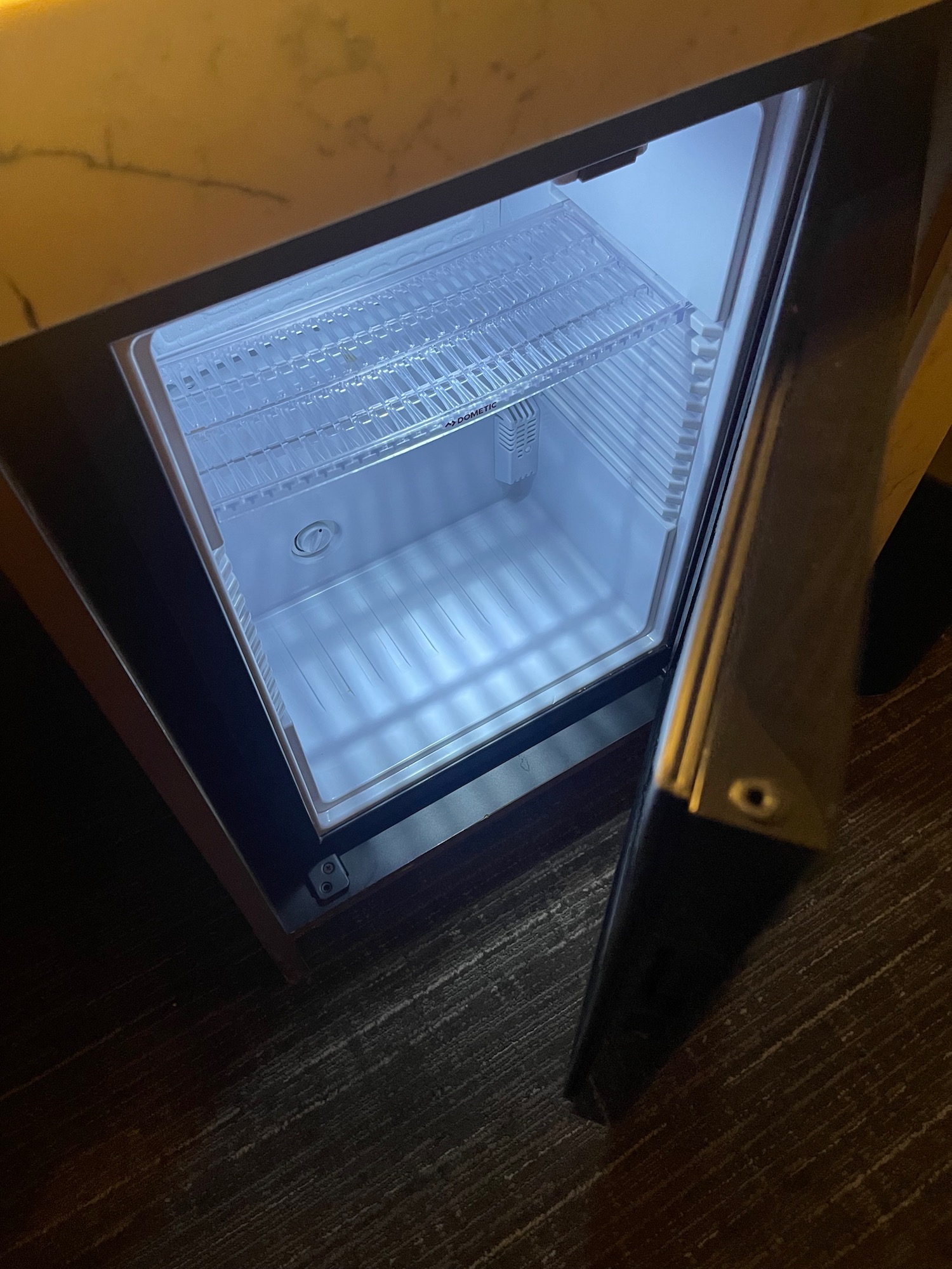 a small refrigerator with a light inside