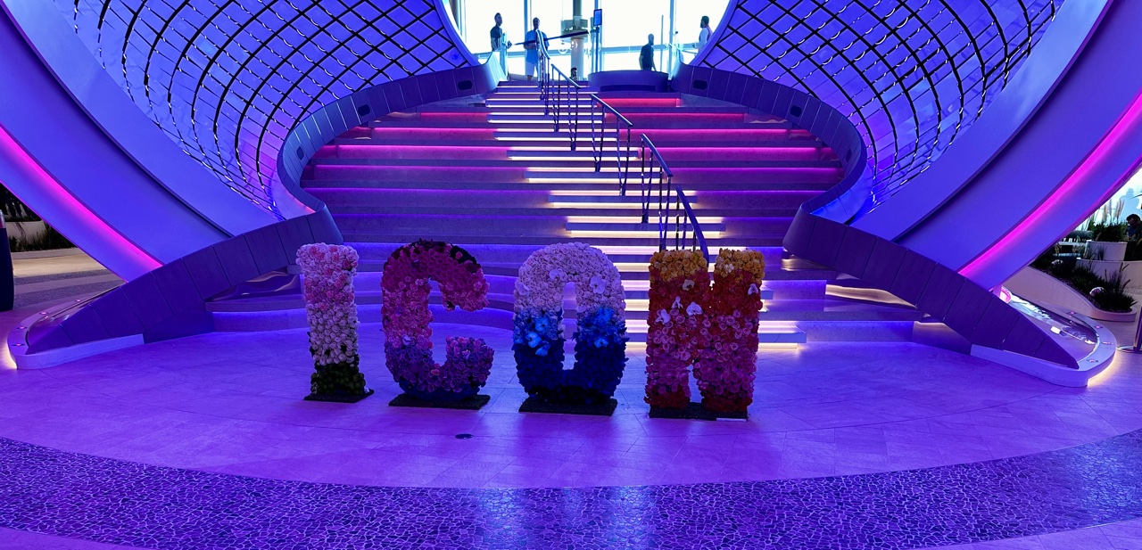 a sign made of flowers in front of a staircase