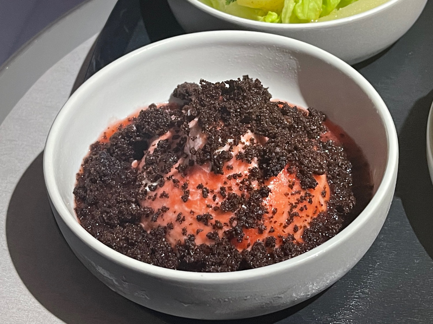 a bowl of food with brown crumbs