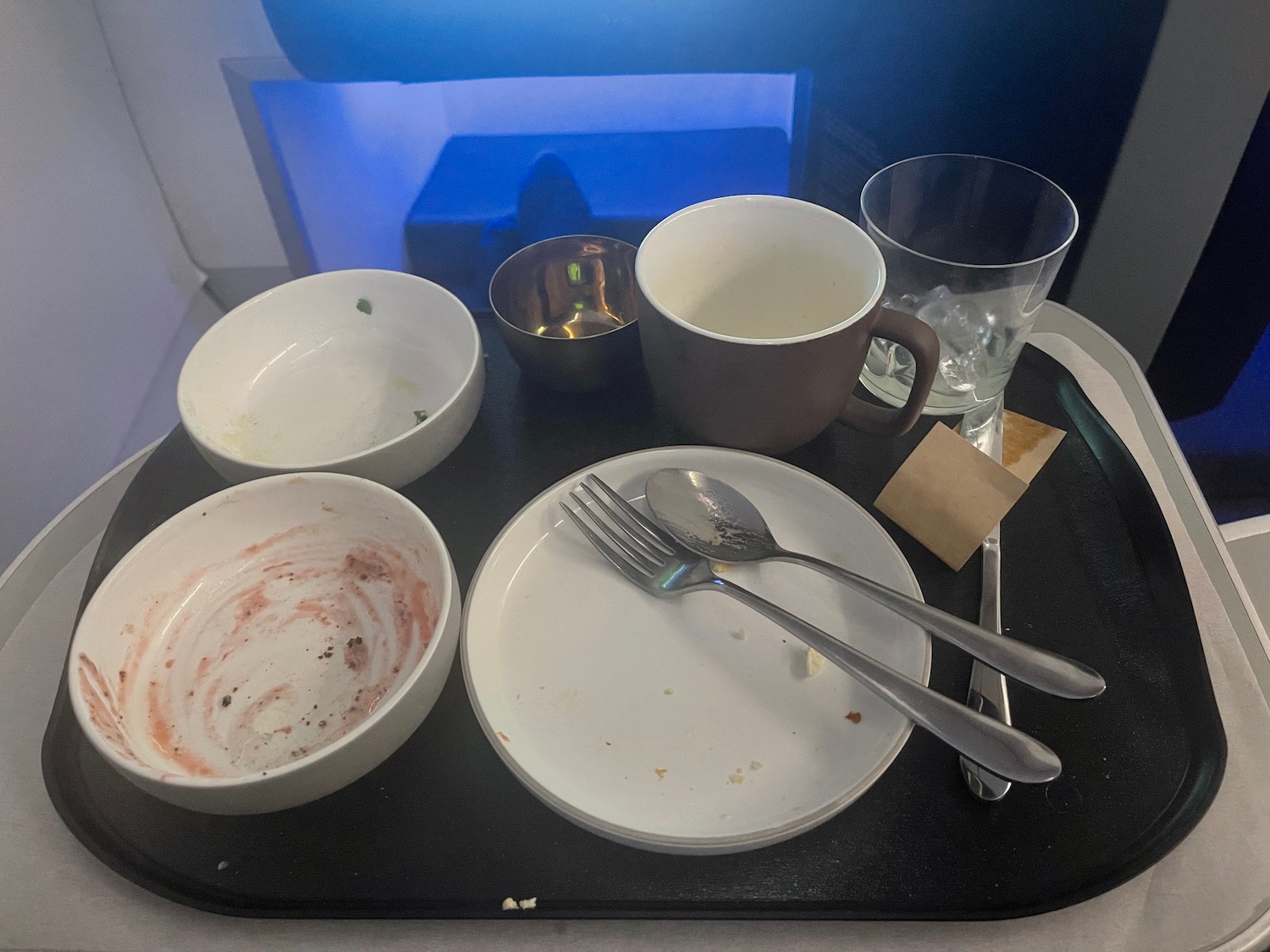 a tray with empty bowls and spoons