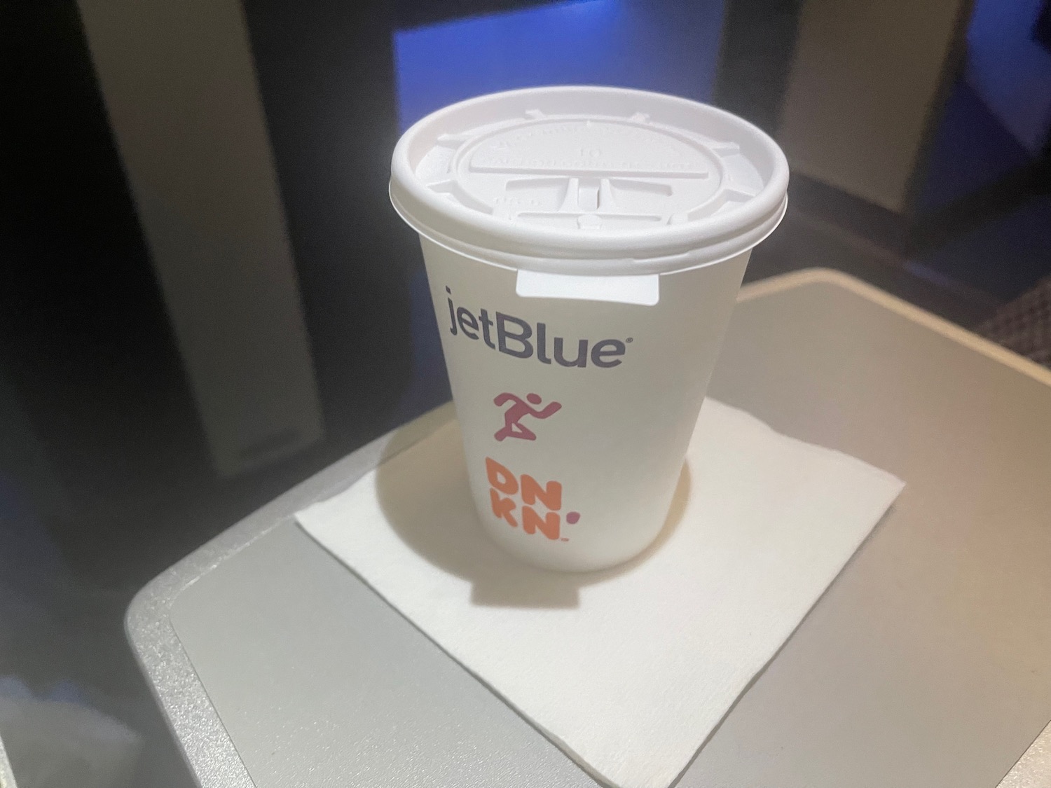 a white cup with a lid on a table