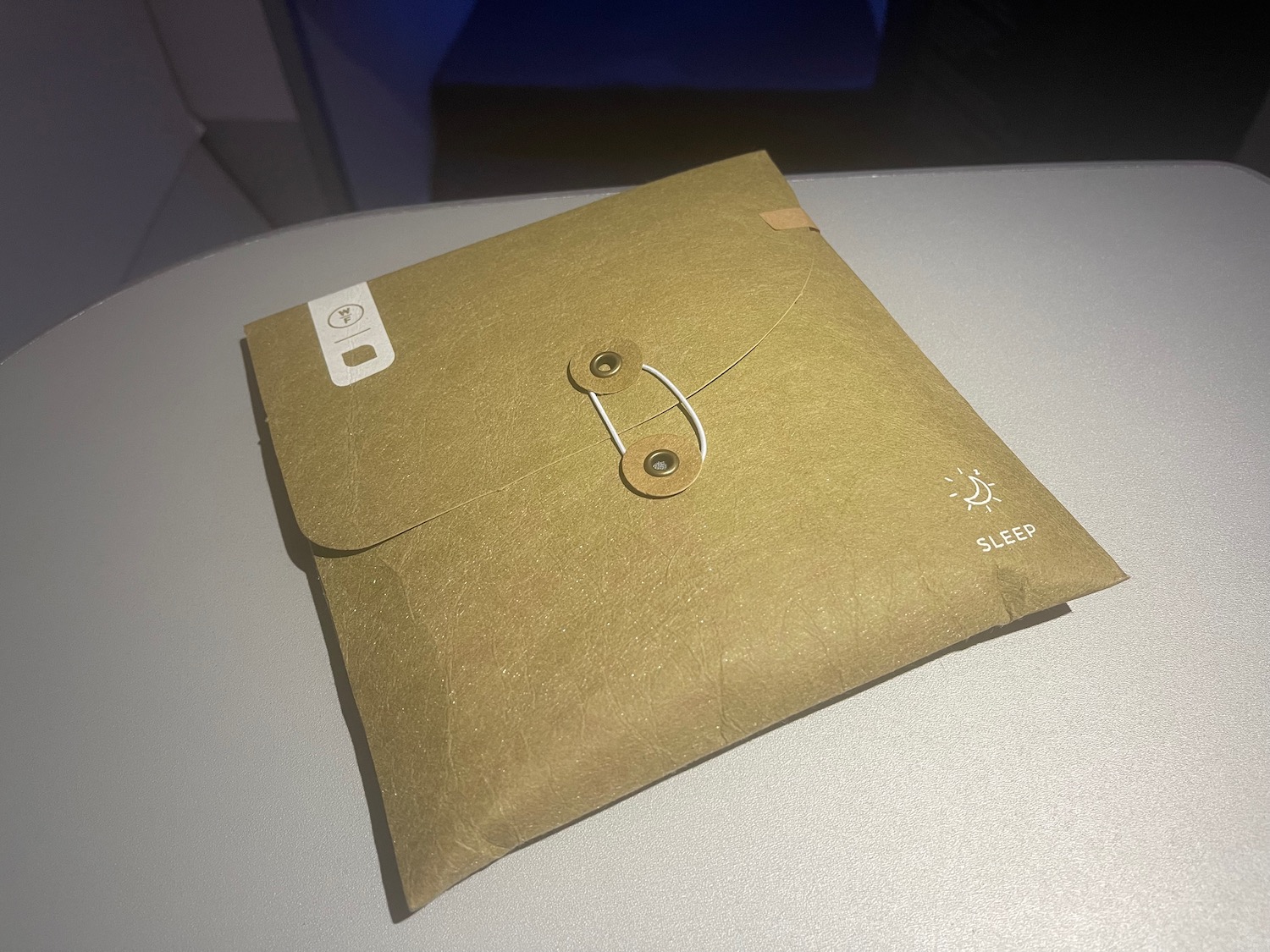 a brown envelope with a button on it