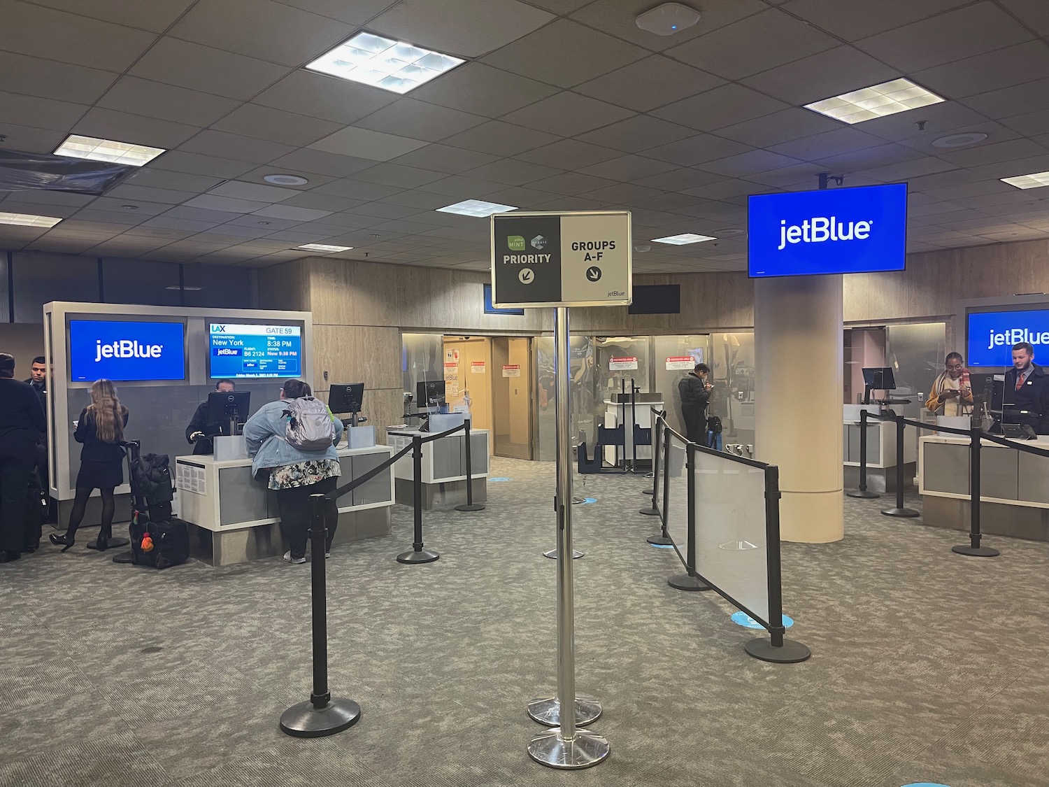 people standing in a line in an airport