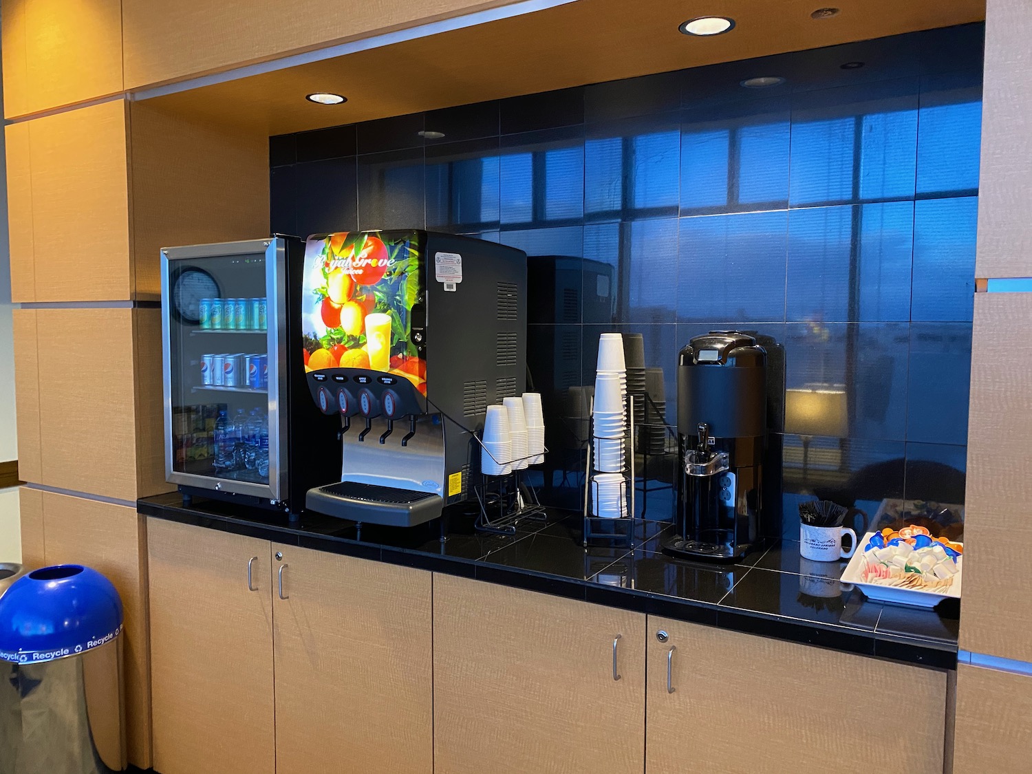 a coffee machine and beverage dispenser on a counter