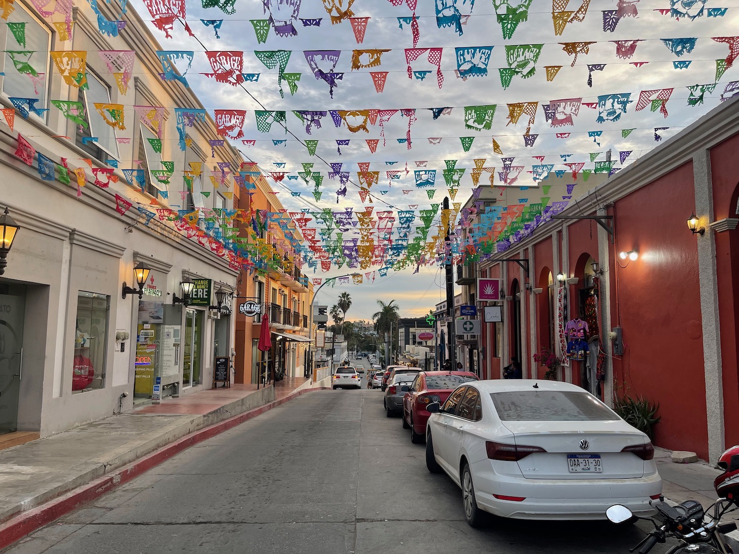 a street with cars and flags