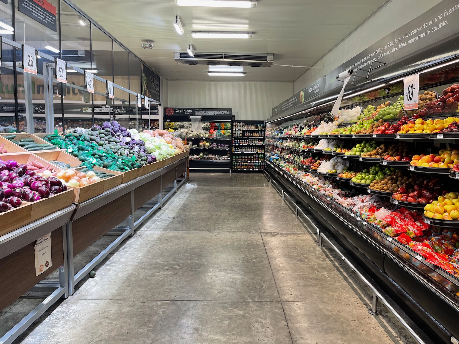 a grocery store with shelves of vegetables