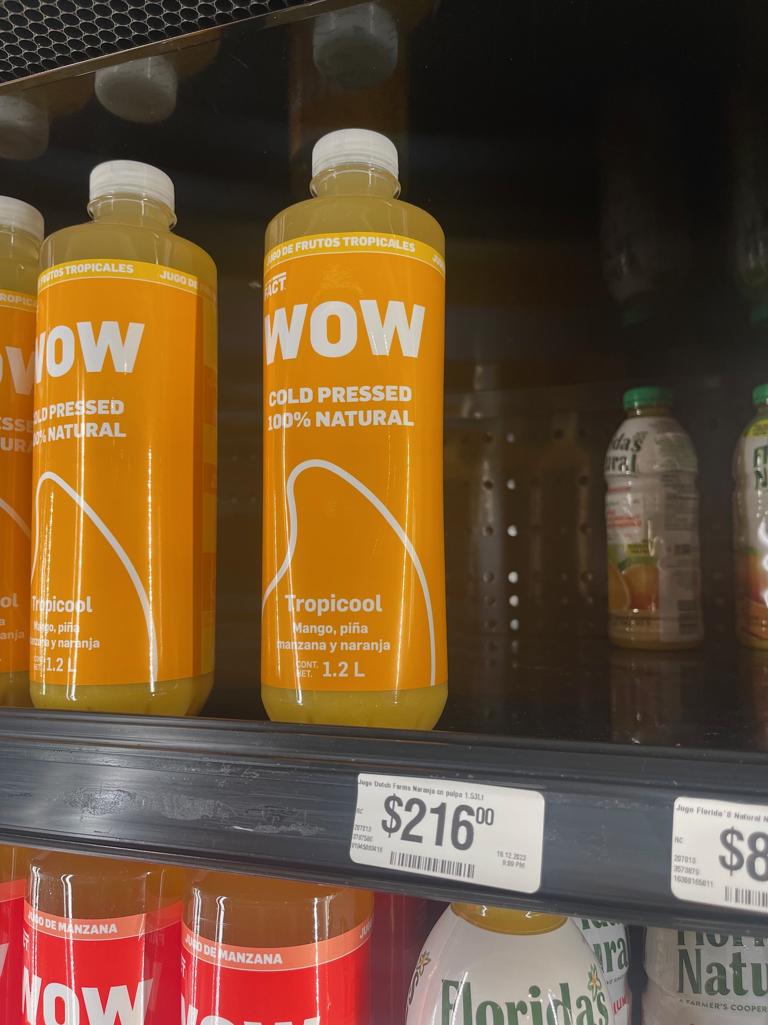 a group of bottles of juice on a shelf