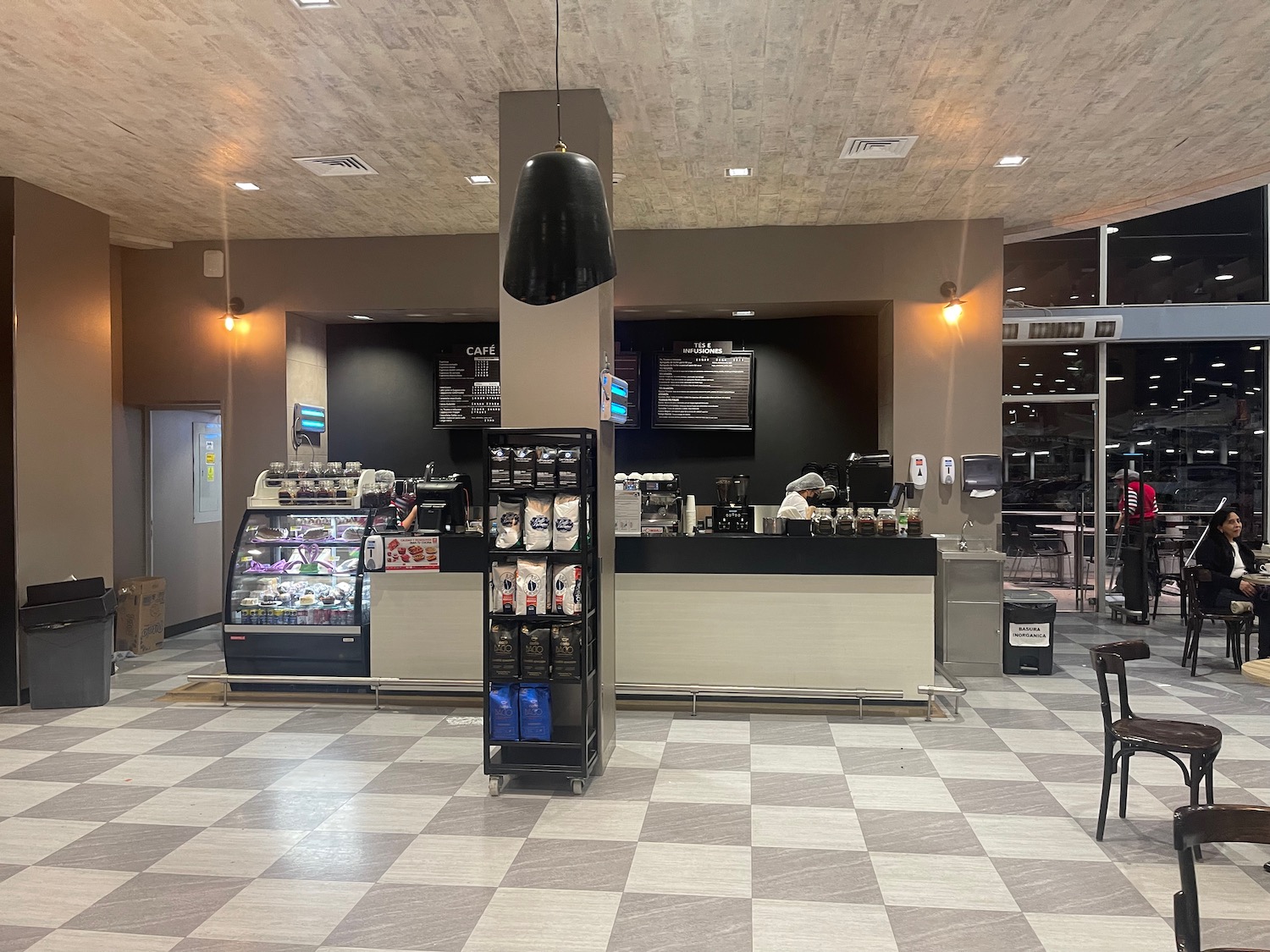 a coffee shop with a checkered floor and a black lamp