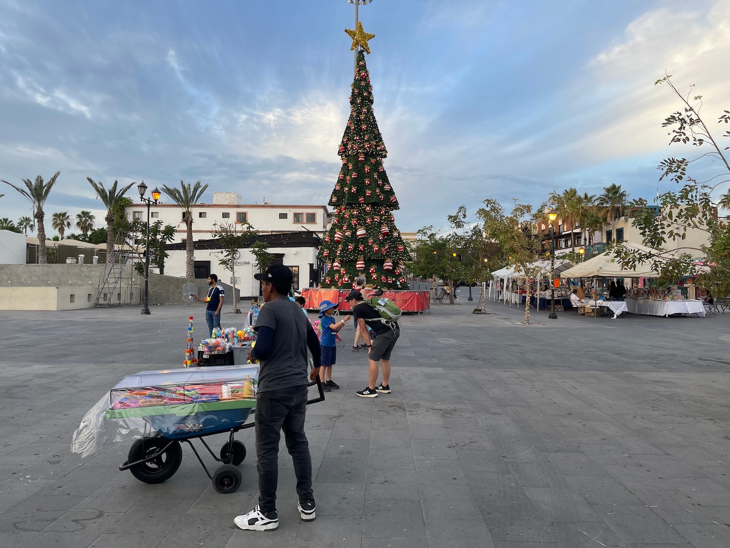 a group of people standing in front of a christmas tree