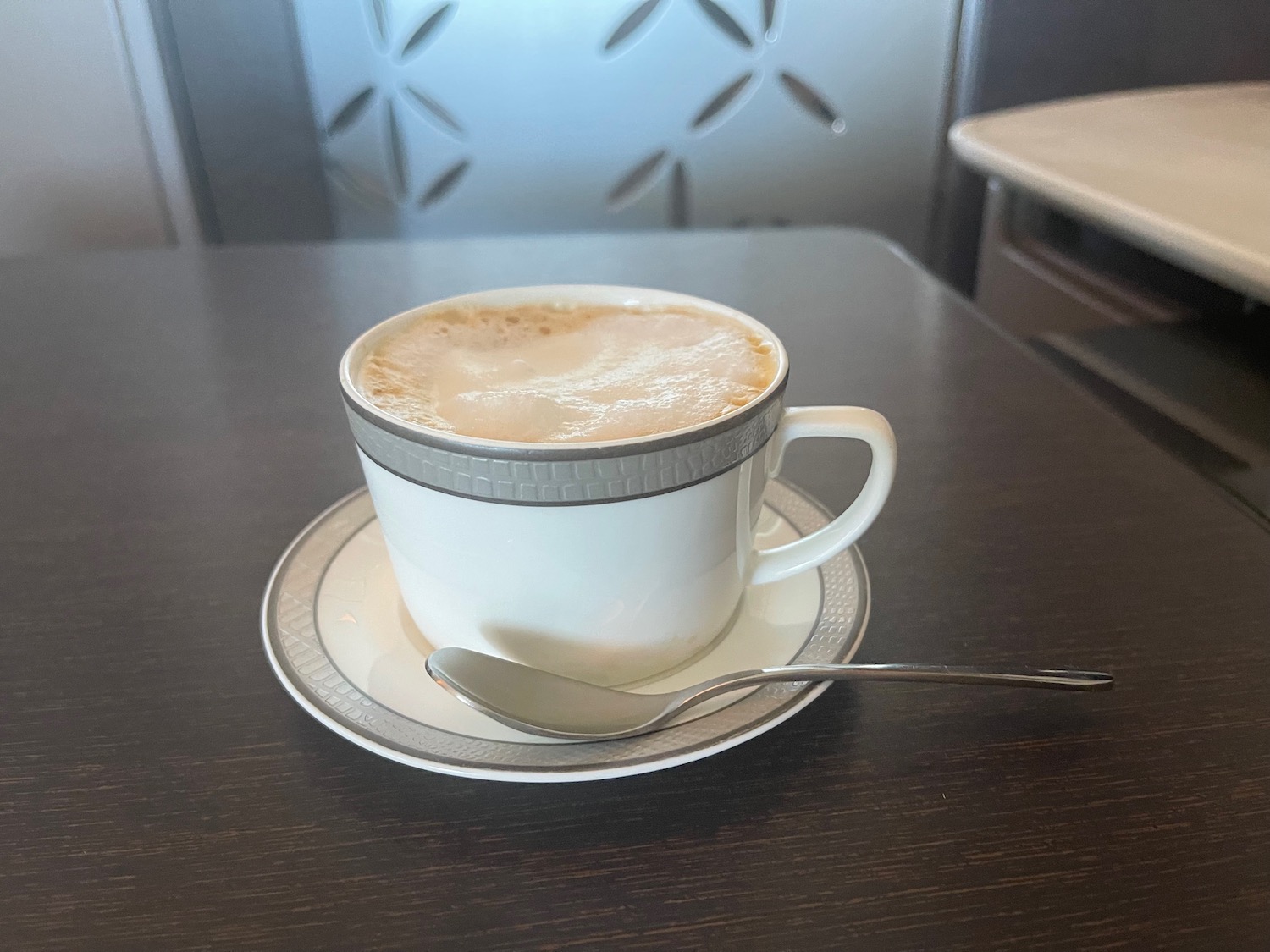 a cup of coffee with a spoon on a saucer