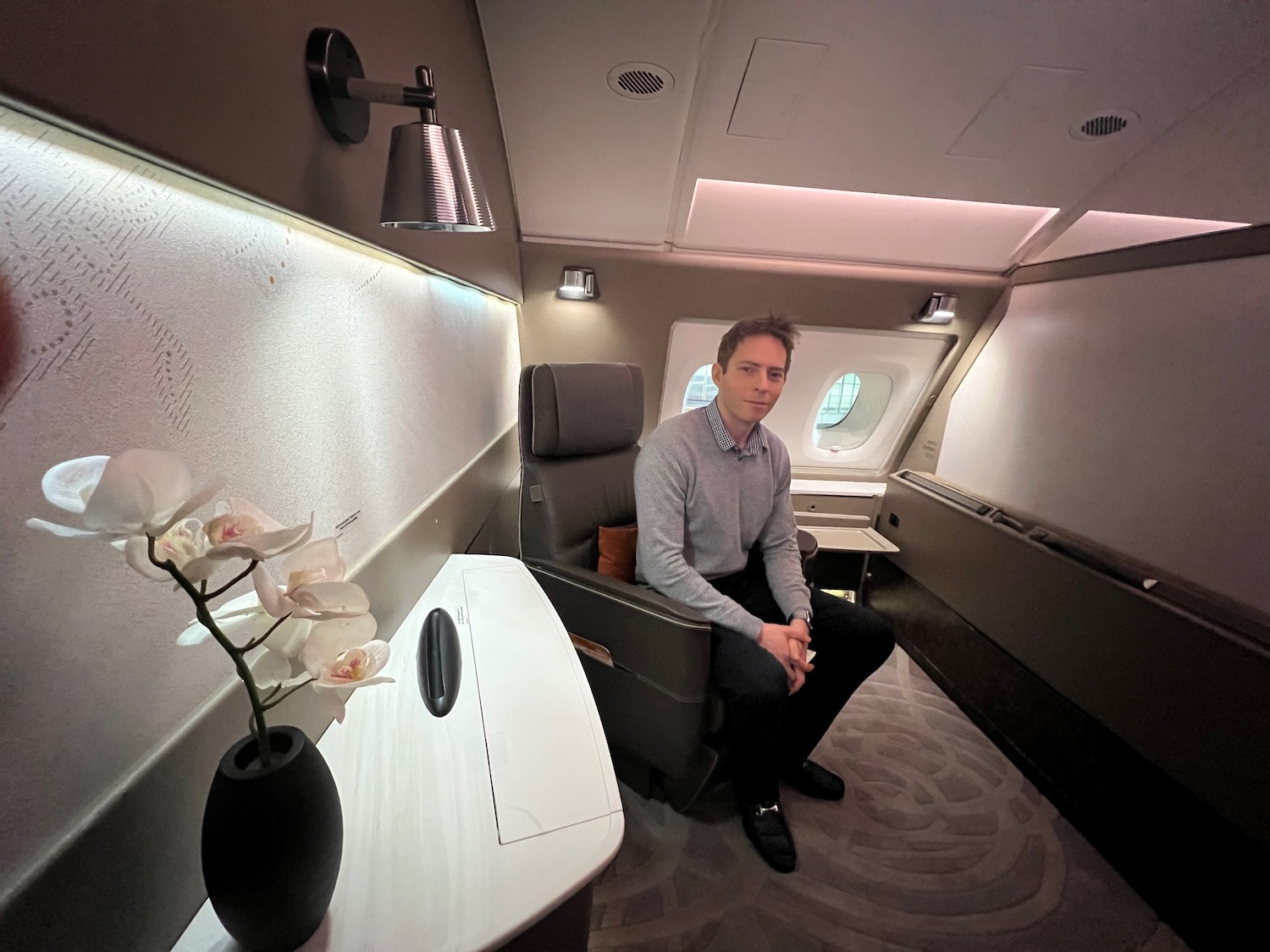 a man sitting in a chair in a plane