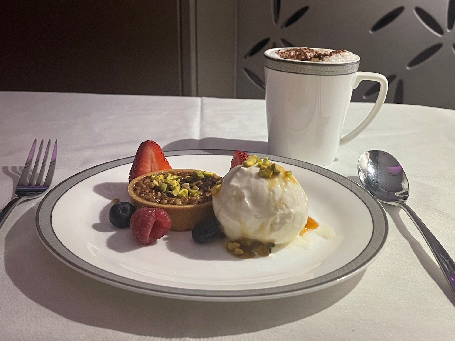 a plate of dessert with ice cream and fruit on it