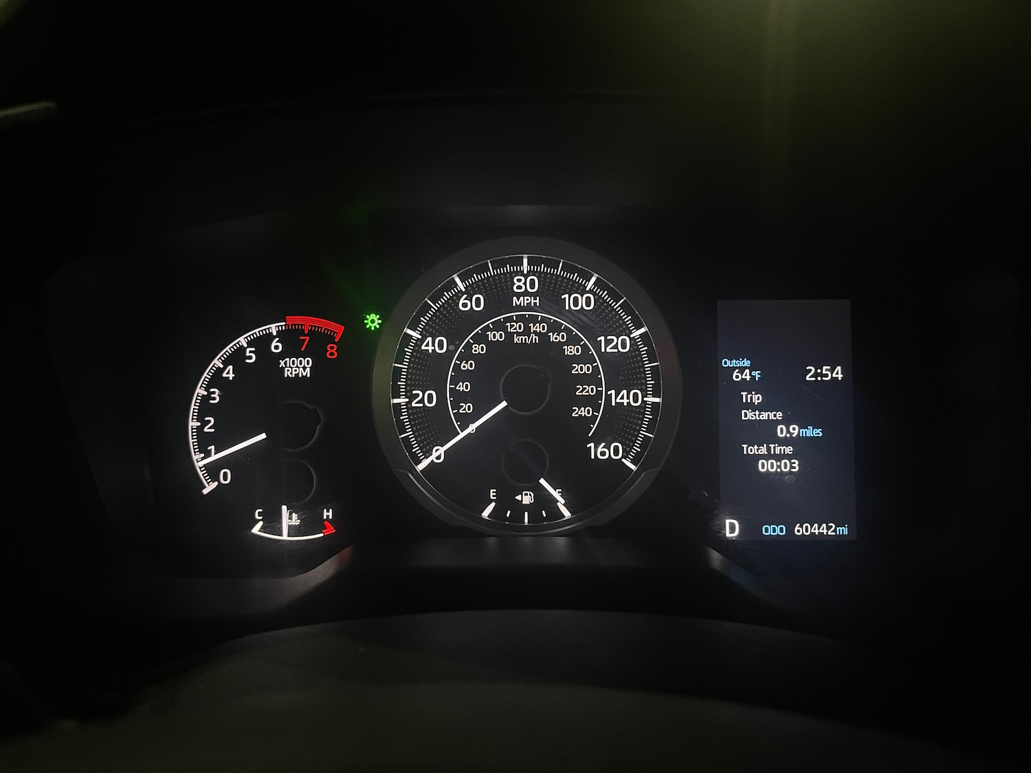 a car dashboard with a speedometer and a display