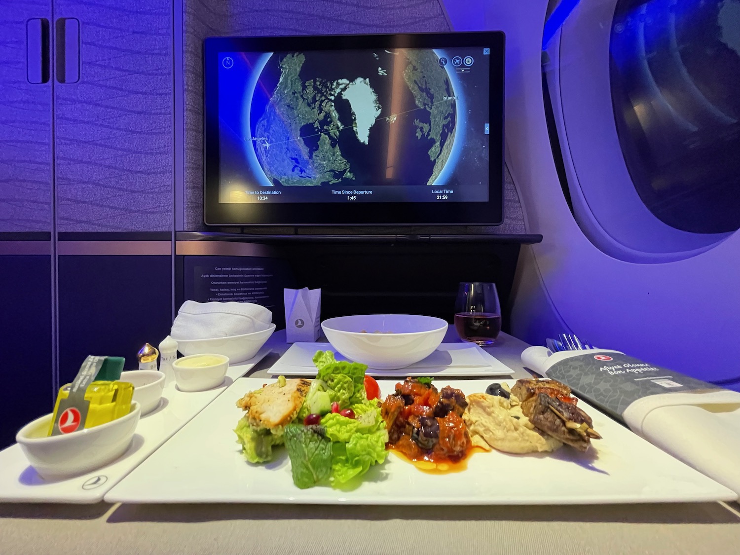 a plate of food on a table with a television