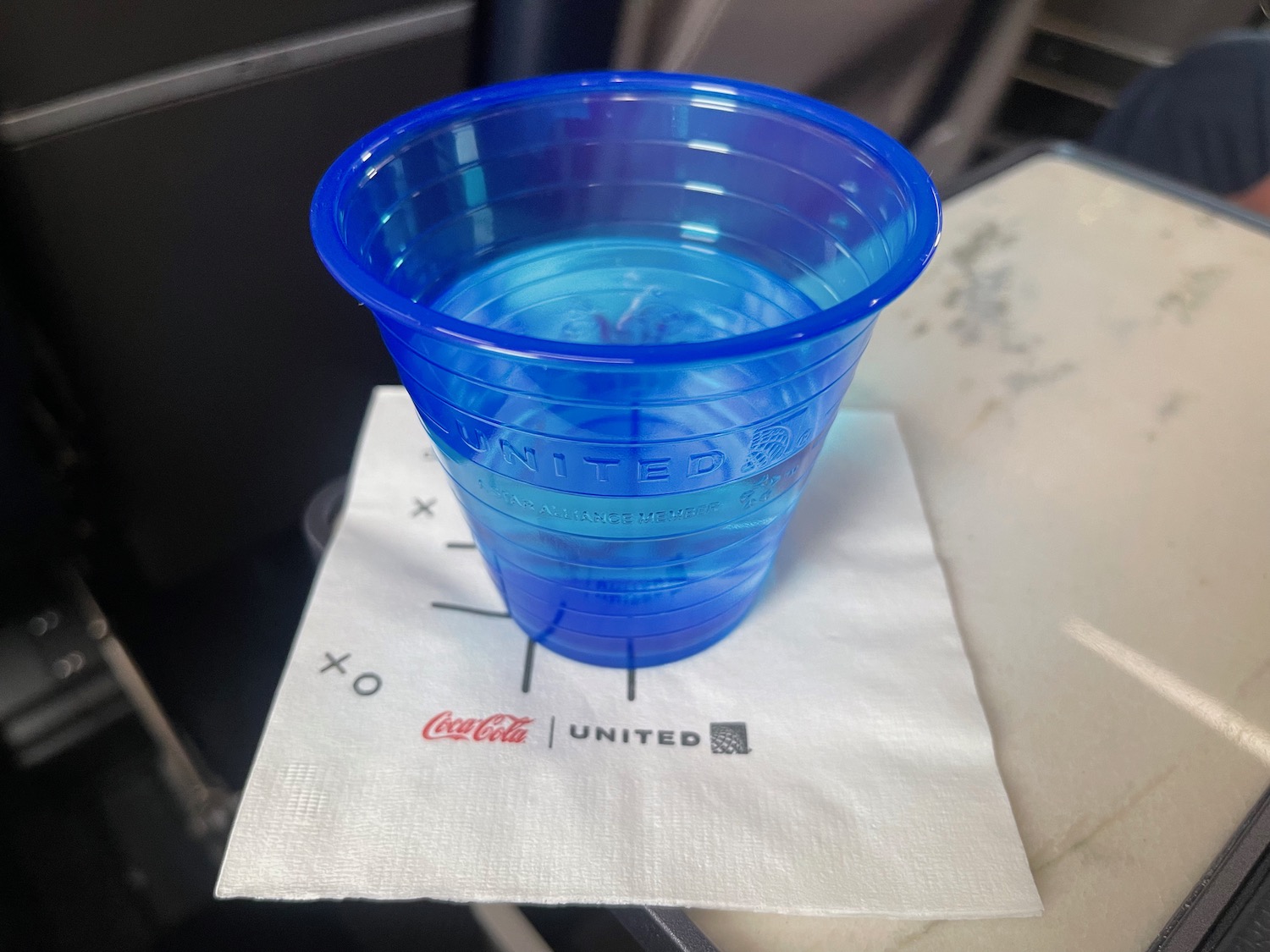 a blue plastic cup on a napkin