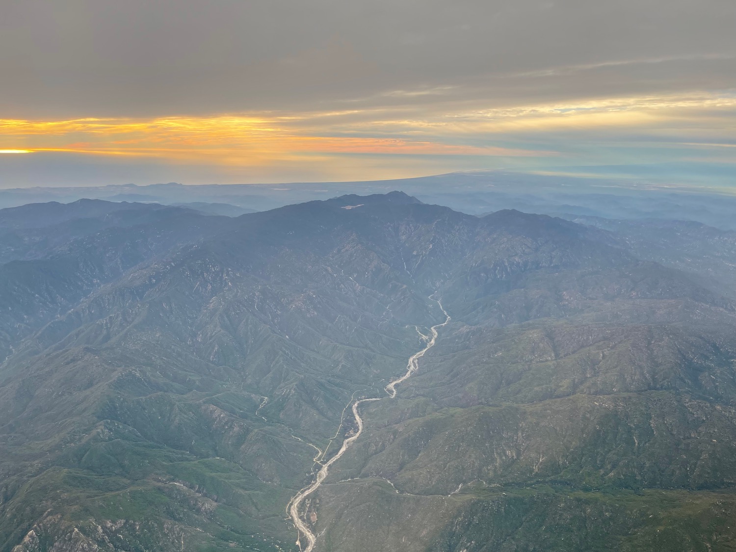 a landscape of mountains and a river