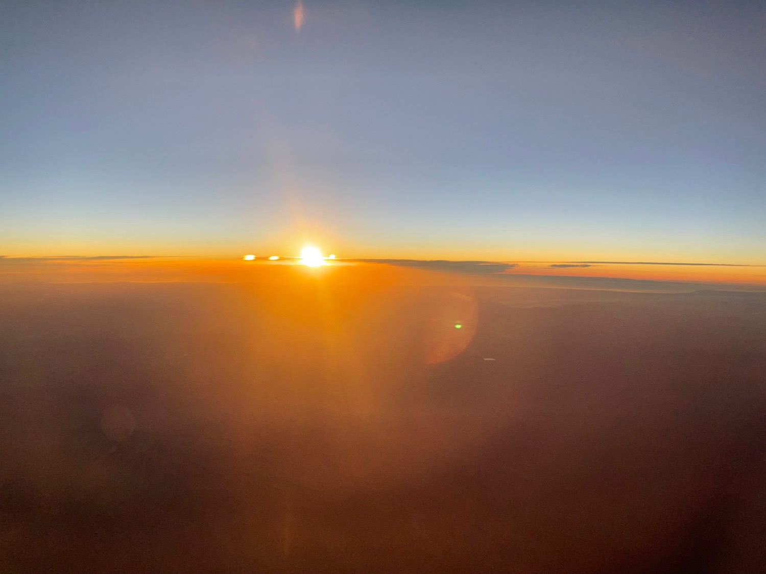 a sun setting over the clouds