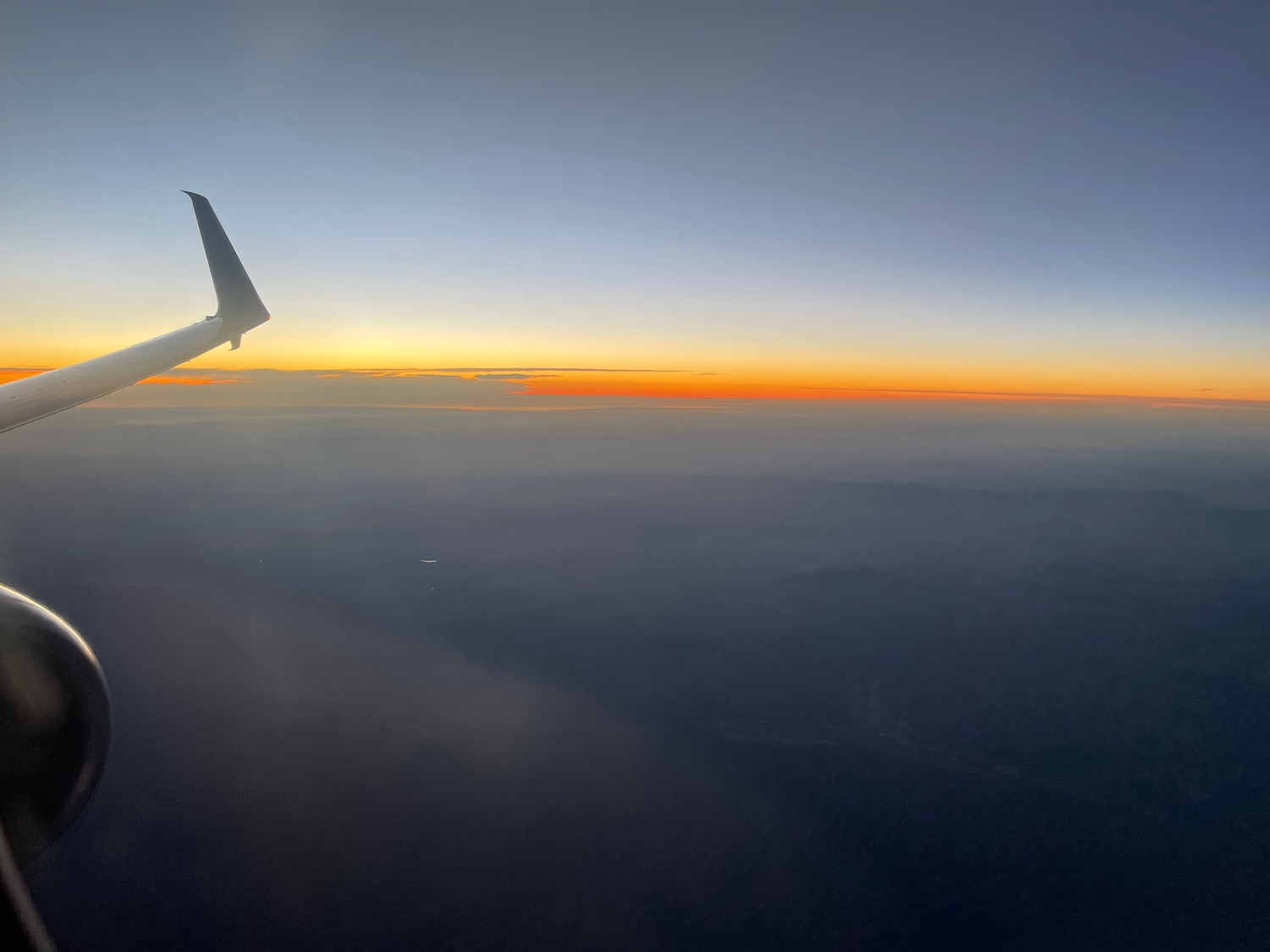 an airplane wing in the sky