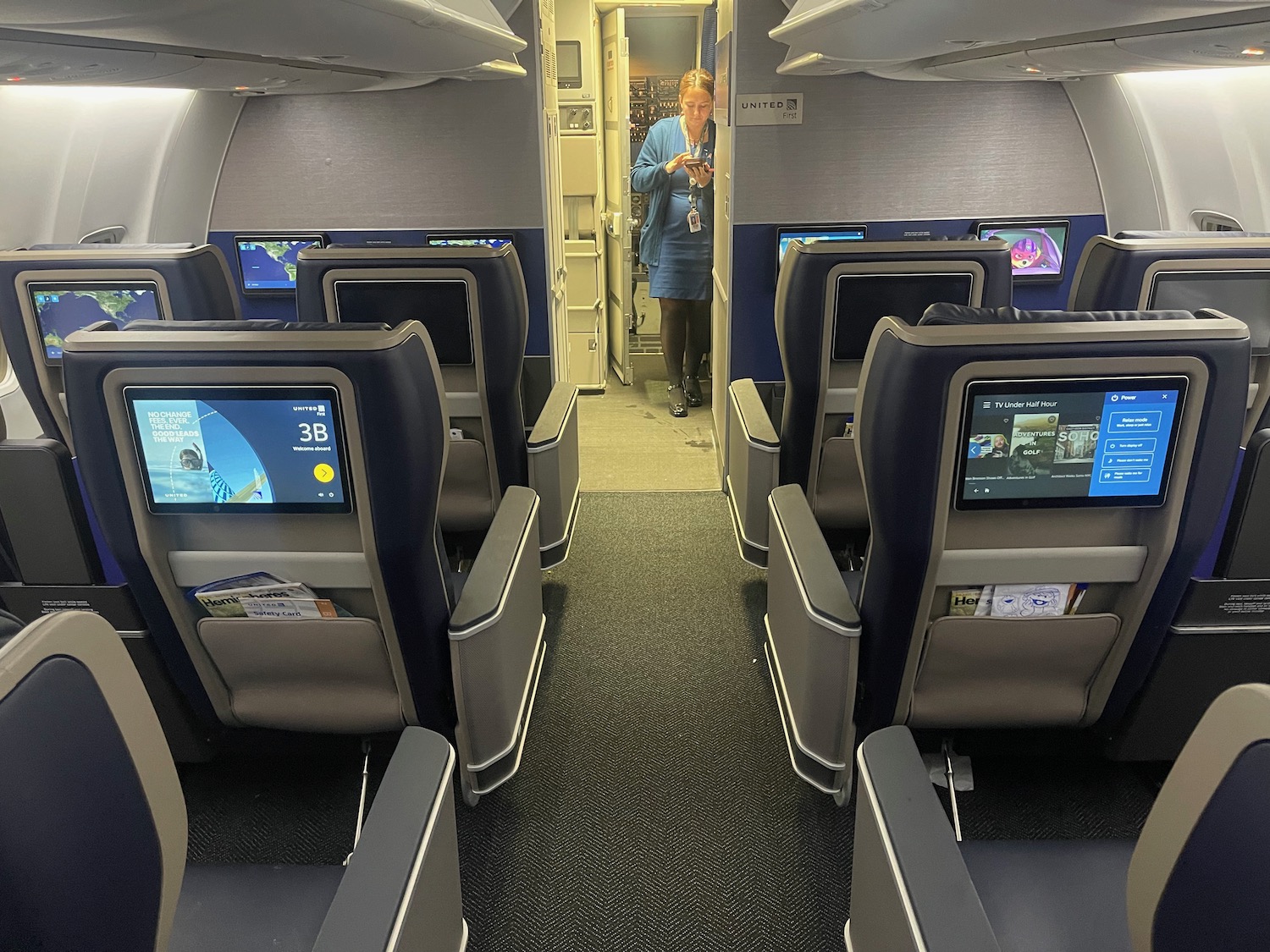 a woman standing in an airplane