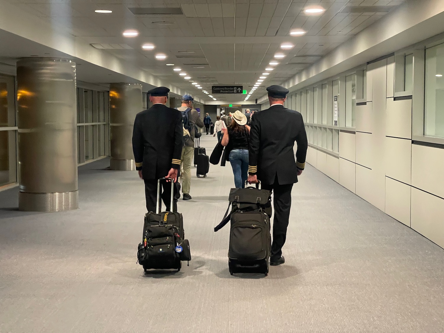 a group of people in uniform with luggage