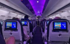 a row of seats with monitors on the side
