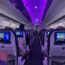 a row of seats with monitors on the side