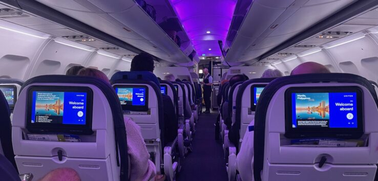 a row of seats with monitors on the side