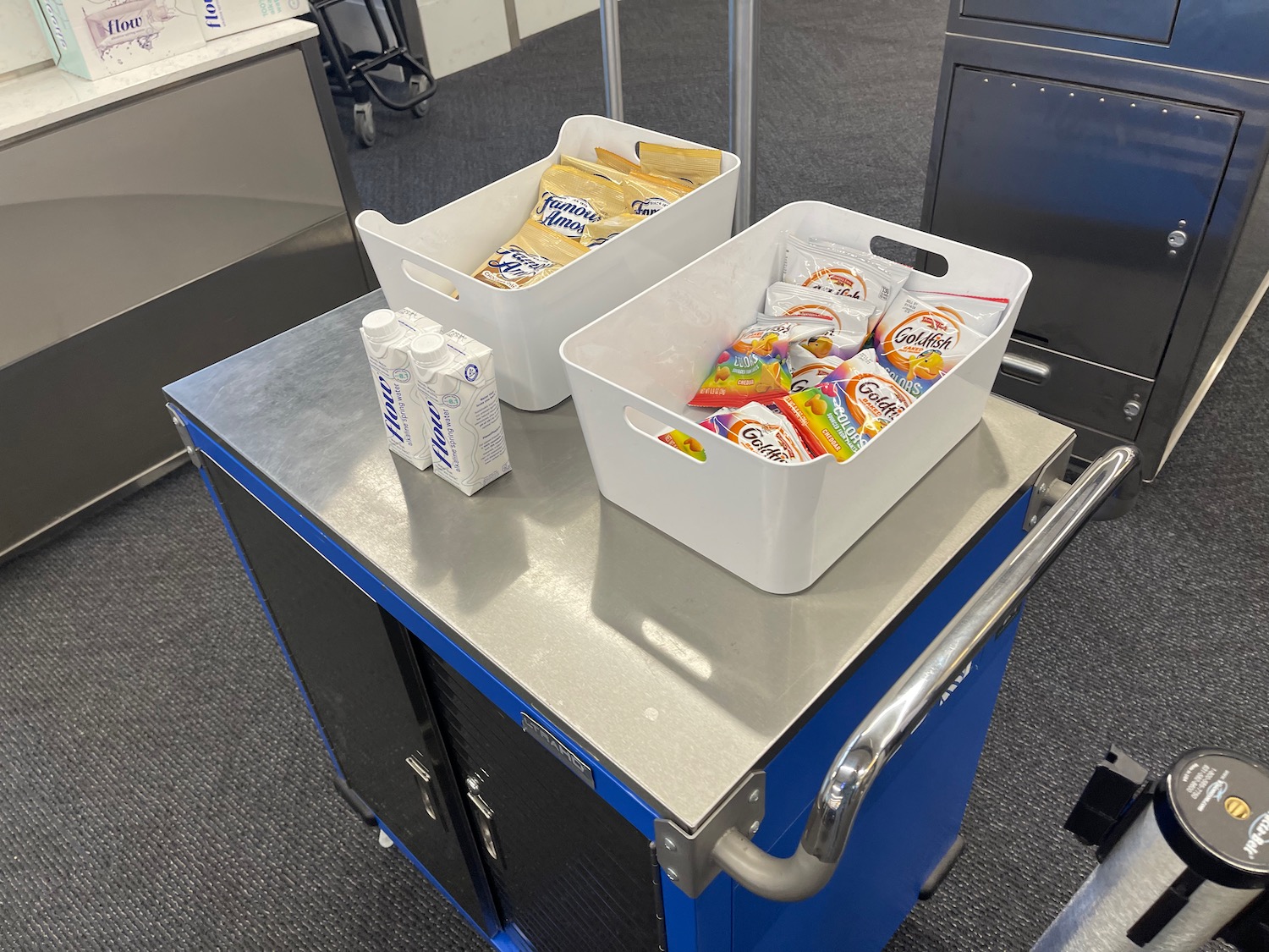 a two white bins with food in them on a metal surface