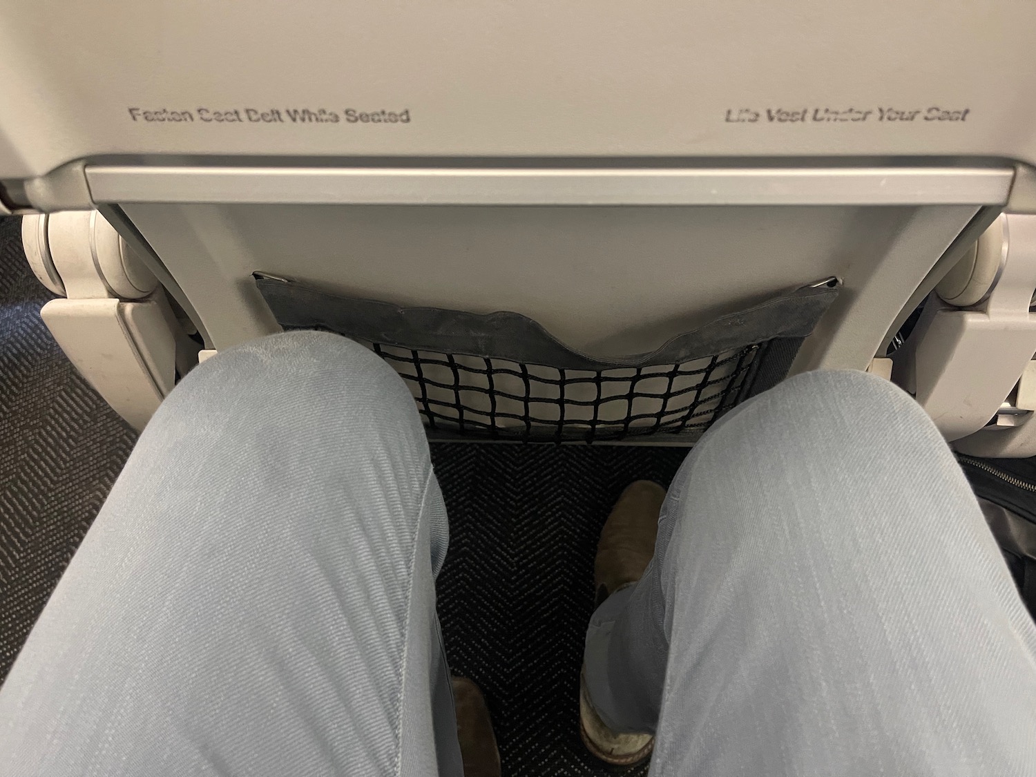 a person's legs in a seat