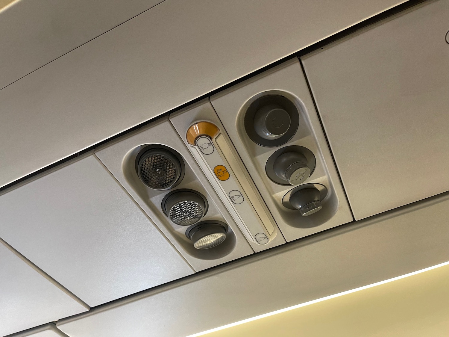 a ceiling with a speaker and a speaker panel