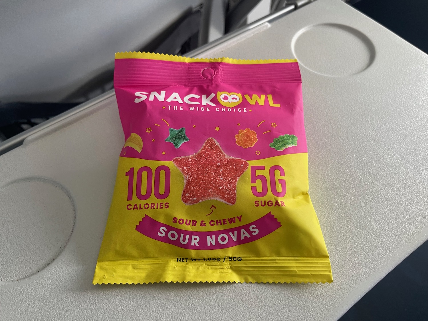 a pink and yellow packet with a star shaped candy