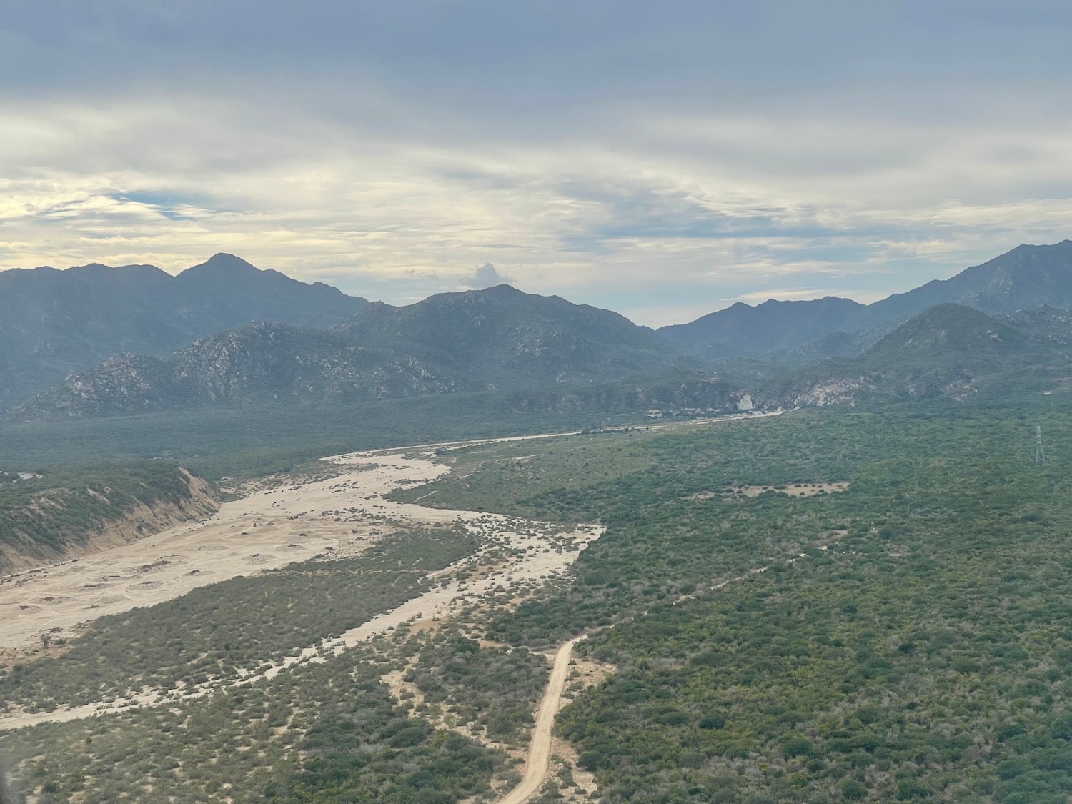 a landscape with a river and mountains