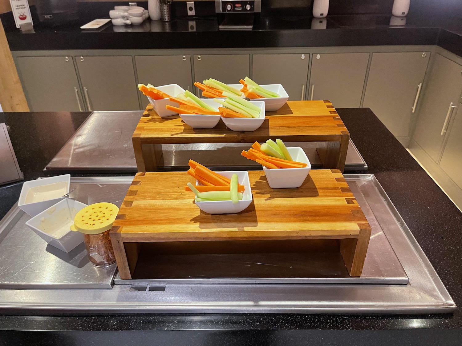 a group of vegetables in bowls on a wooden tray