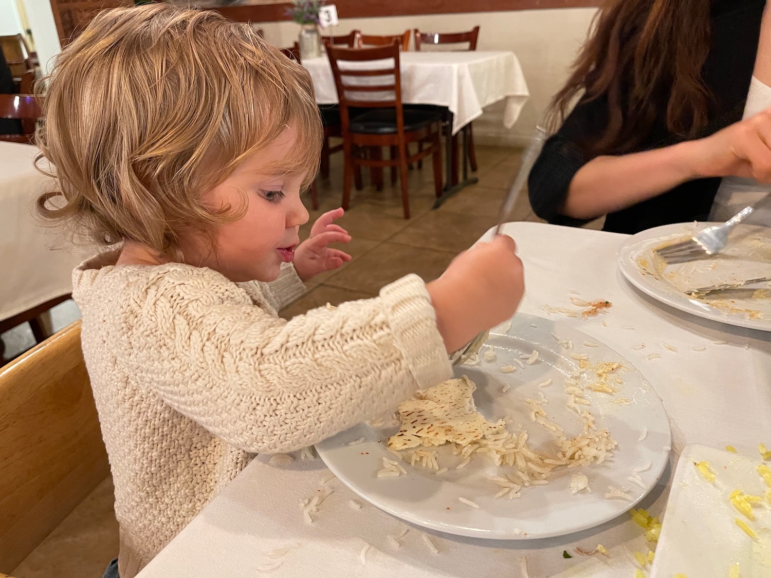 a child eating food at a restaurant