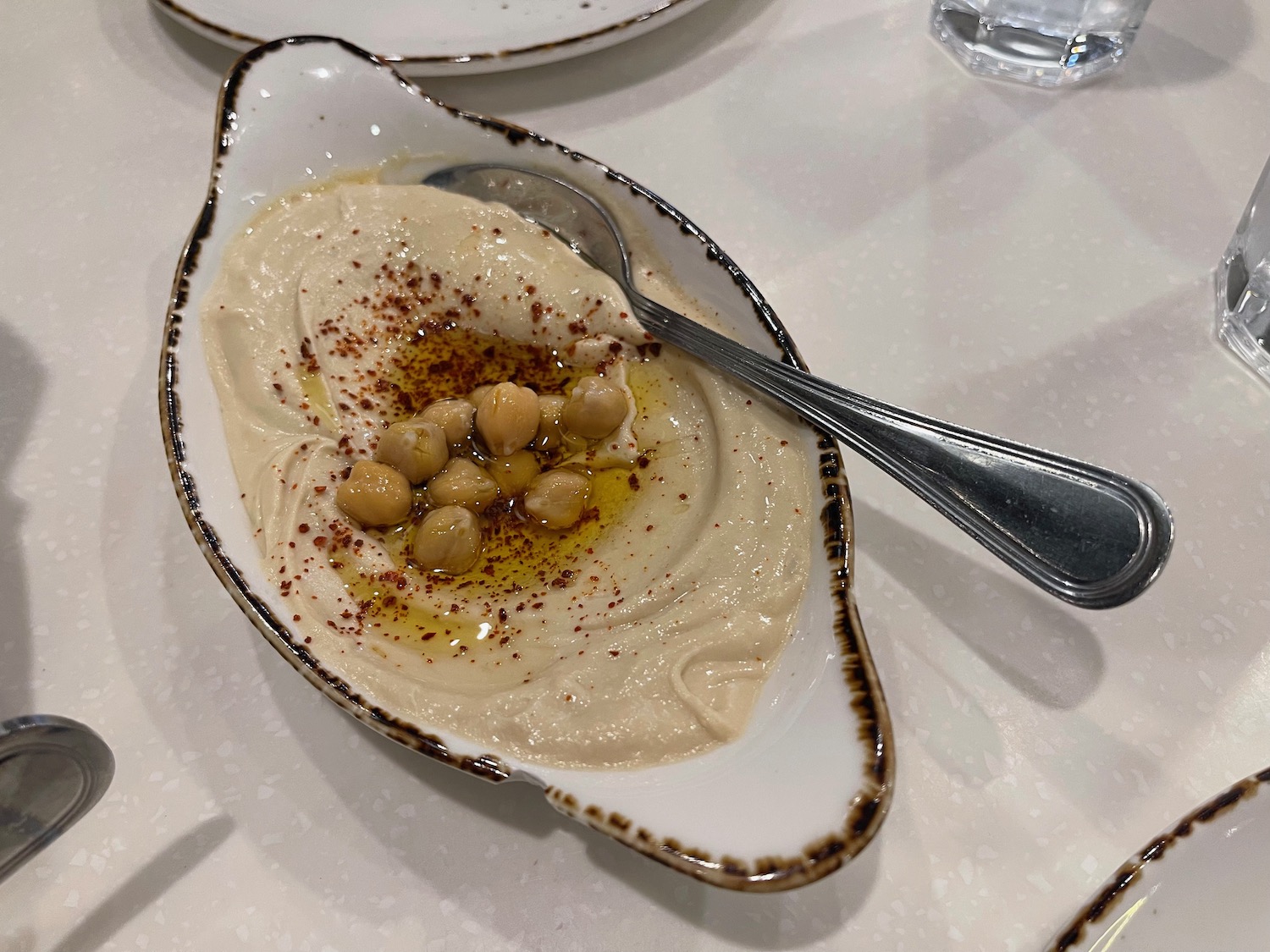 a bowl of hummus with a spoon