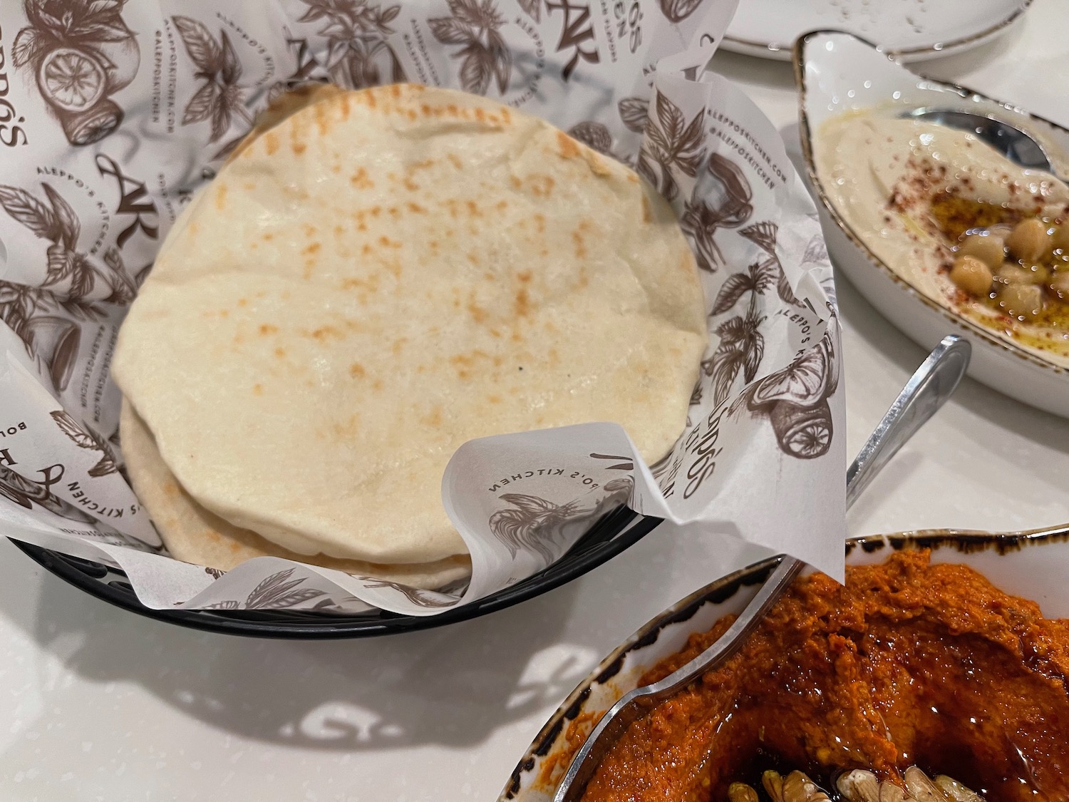 a tortilla in a bowl next to a bowl of food