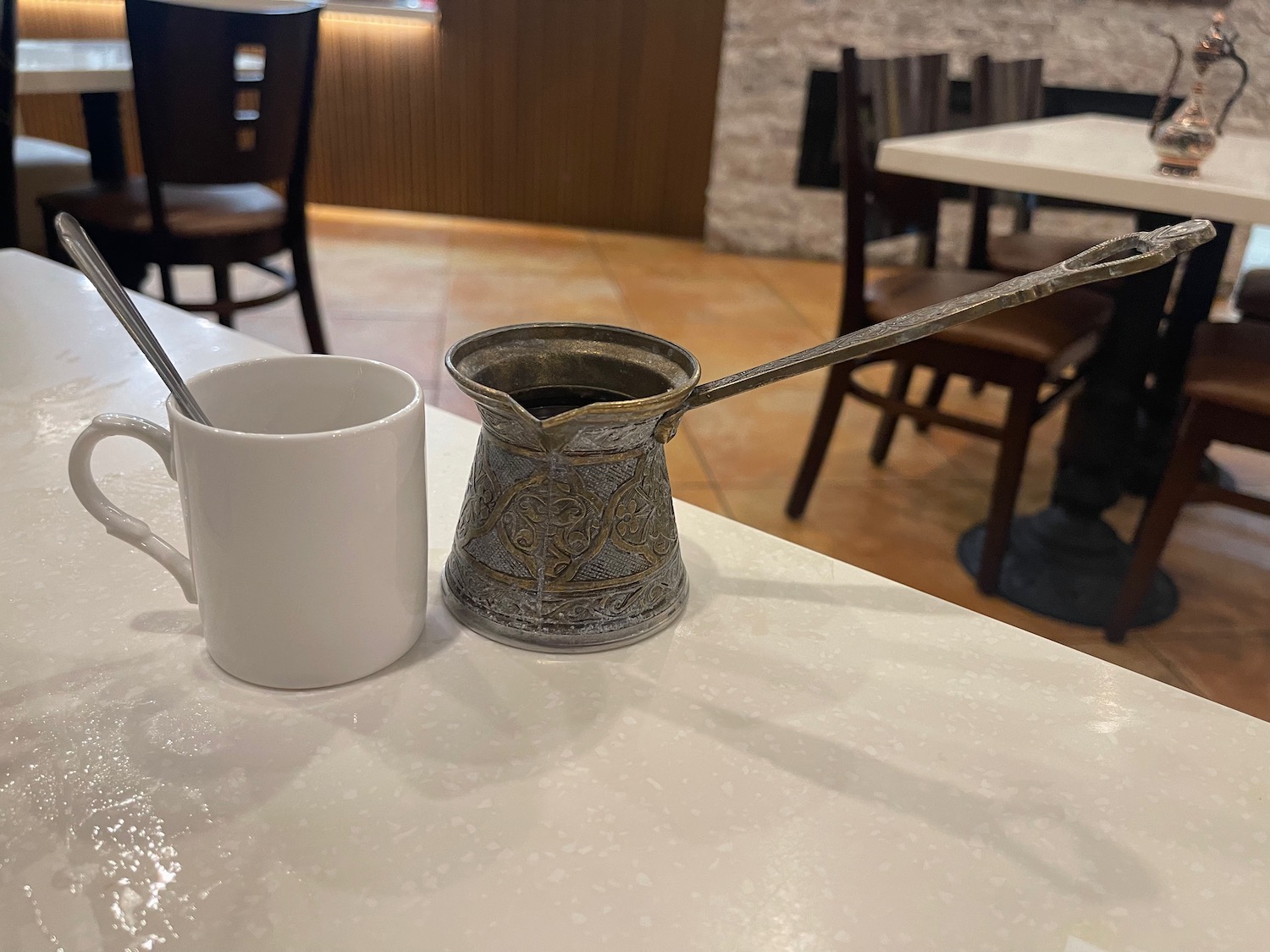 a coffee pot and a mug on a table